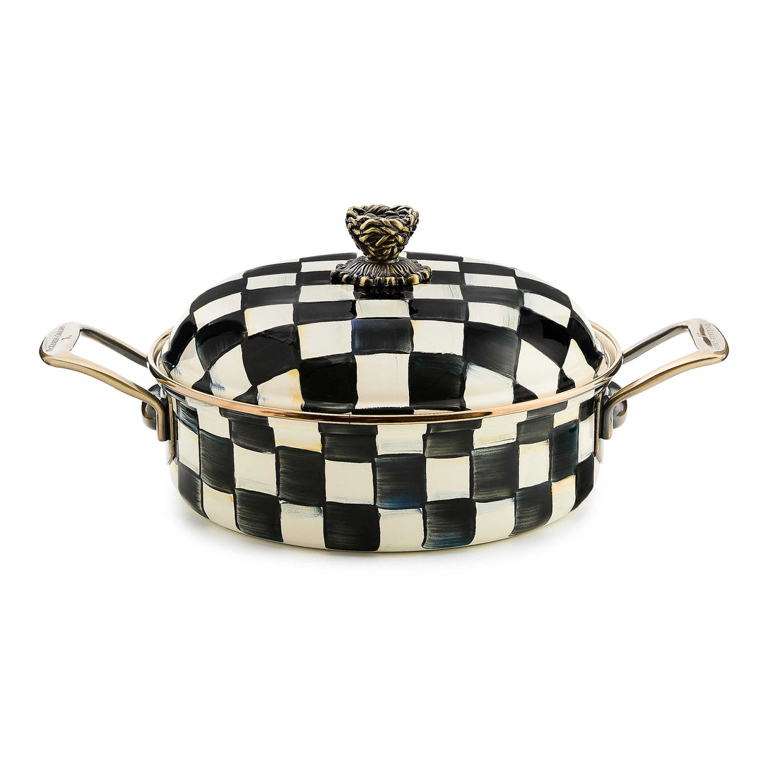 Courtly Check enamel 3 quart casserole with black and white hand-painted pattern and brass handles.