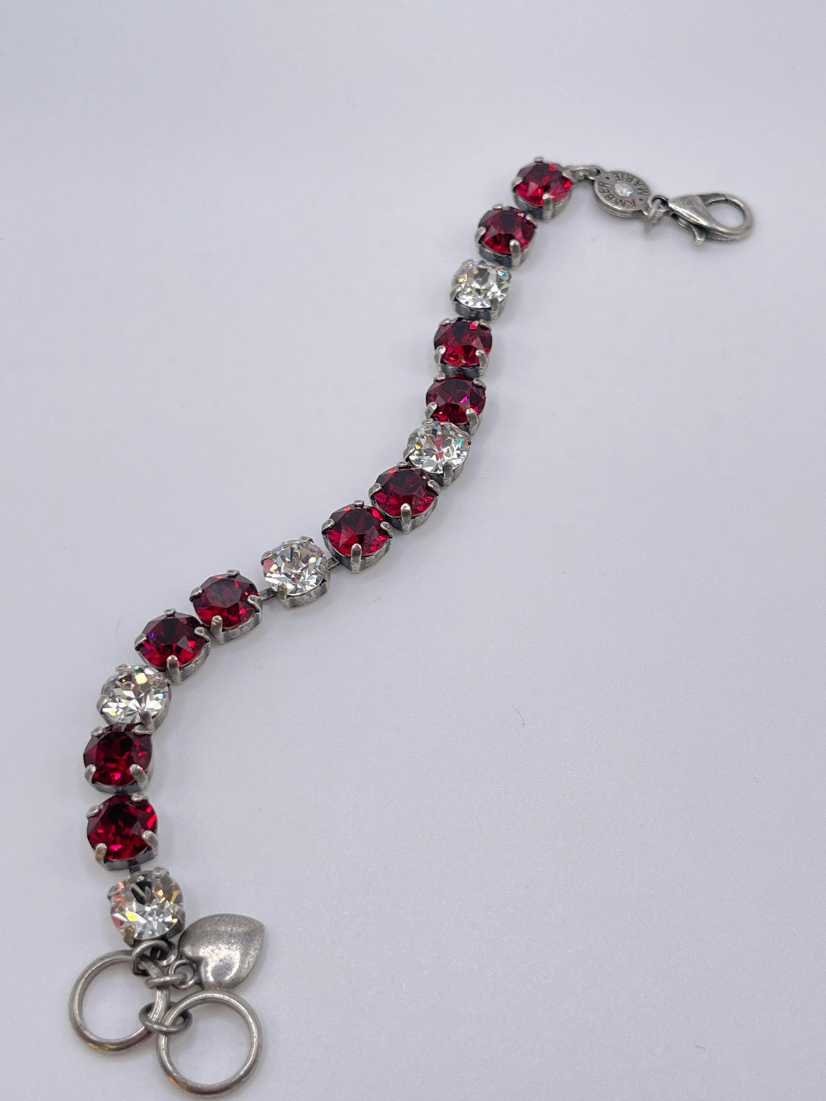 Classic Rome bracelet featuring deep red, black, and clear stones in a sleek silhouette.