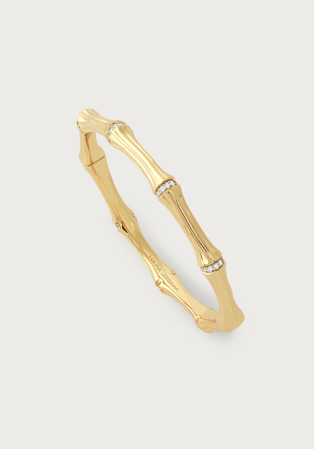 Gold-plated bamboo-shaped hinged bangle with crystal pavé accents on each segment.