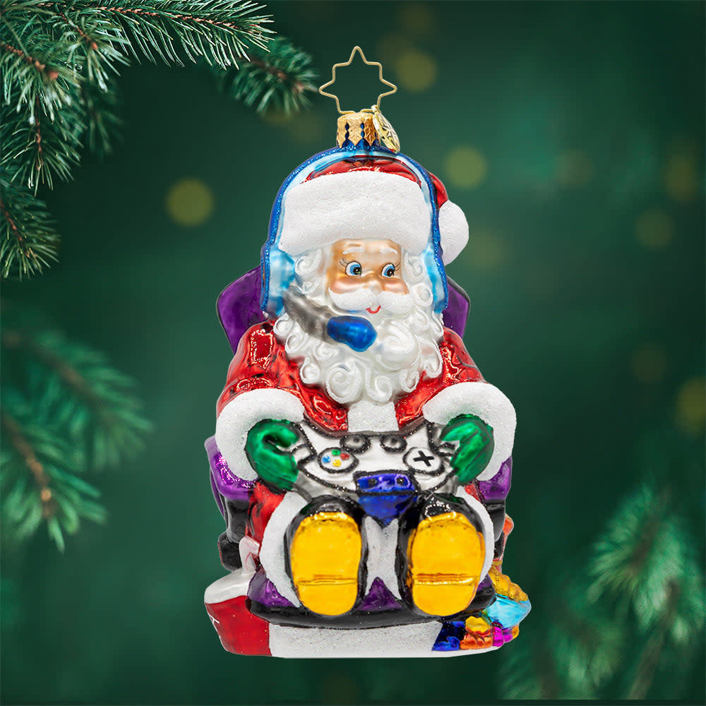 Game Master Santa ornament: a red and white gaming-themed Christmas tree decoration featuring a joystick-wielding Santa in turbo sleigh silhouette.