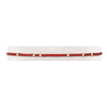 Bright red Gameday Hope Unwritten bracelet featuring a seed bead pattern with gold-filled accents on elastic.