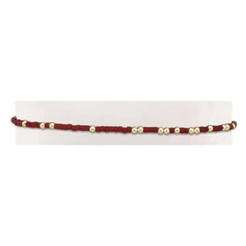 Crimson seed bead bracelet with gold accents on elastic cord
