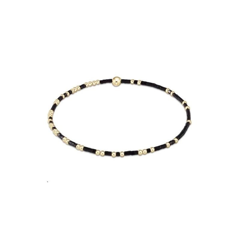 Onyx Gameday Hope Unwritten bracelet featuring a black seed bead pattern with gold-filled accents on elastic.