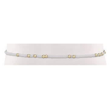 White beaded Gameday Hope Unwritten bracelet with gold accents on elastic cord