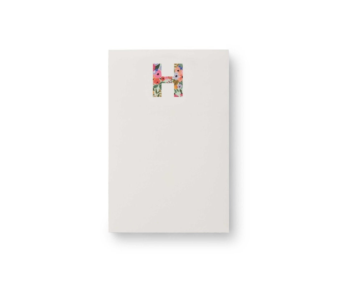 Garden Party monogram notepad with floral illustrations on white paper.