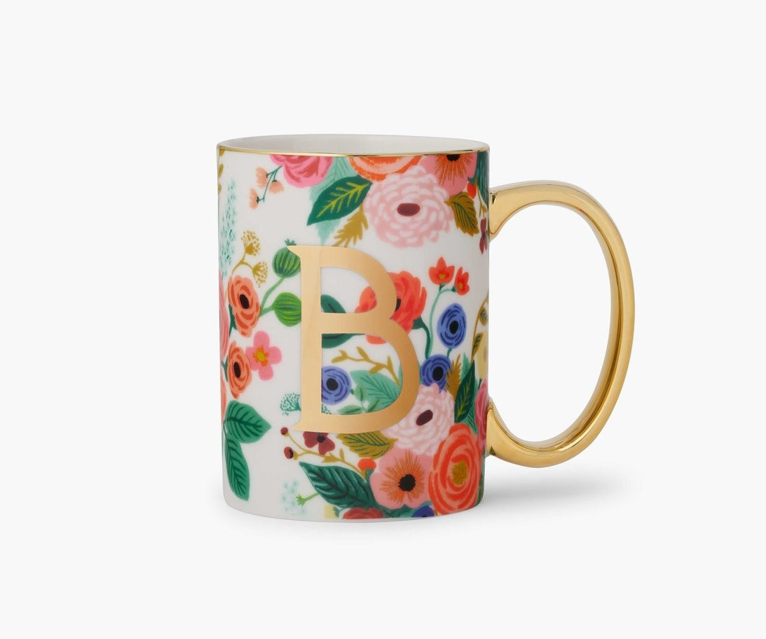 Porcelain mug with gold monogram, gilded rim, handle, and illustrated garden party design.