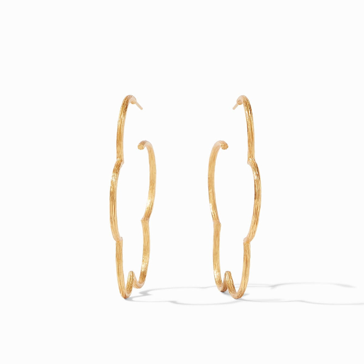 Large gold hoop earring with a floral Gardenia etched pattern.