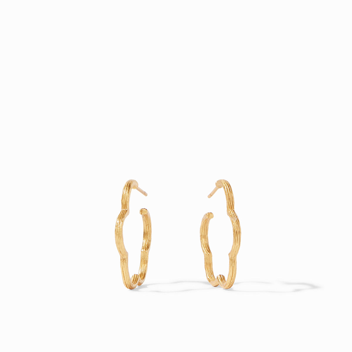 Slender gold hoop earring with a floral Gardenia silhouette featuring an etched textured finish.