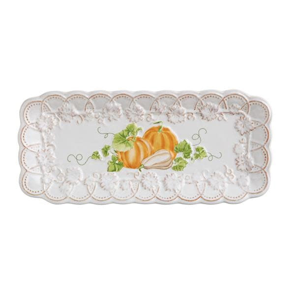 Pumpkin-colored stoneware scalloped tray measuring 4 by 9 inches.
