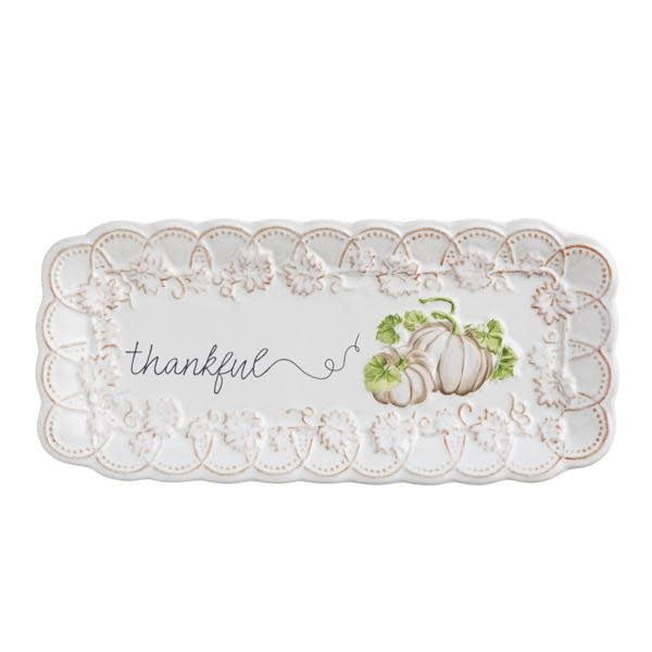 Stoneware scalloped-edge tray in autumn tones measuring four by nine inches