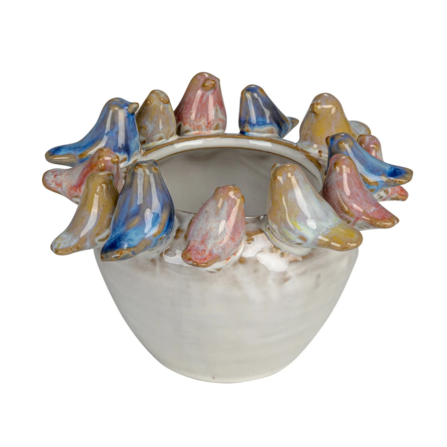 Round stoneware planter with reactive glaze finish featuring a bird silhouette pattern on the rim.