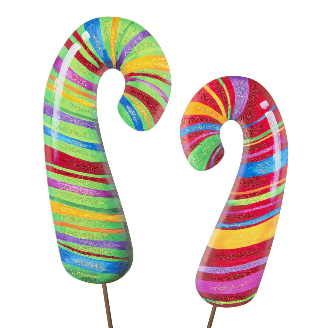 Red candy cane shaped decorative stakes with white stripes