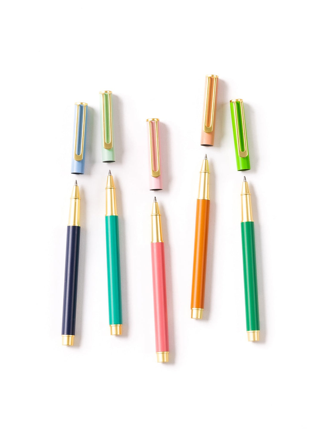 Five color block pens in navy, teal, pink, orange, and green with gold accents and matching caps.