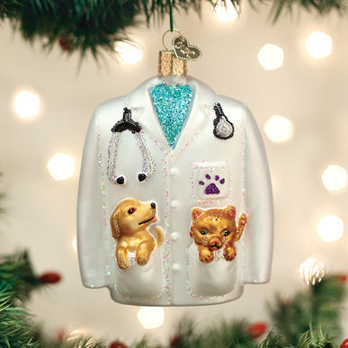 Glass veterinarian's coat ornament with a stethoscope, a puppy, and a kitten in the pockets.