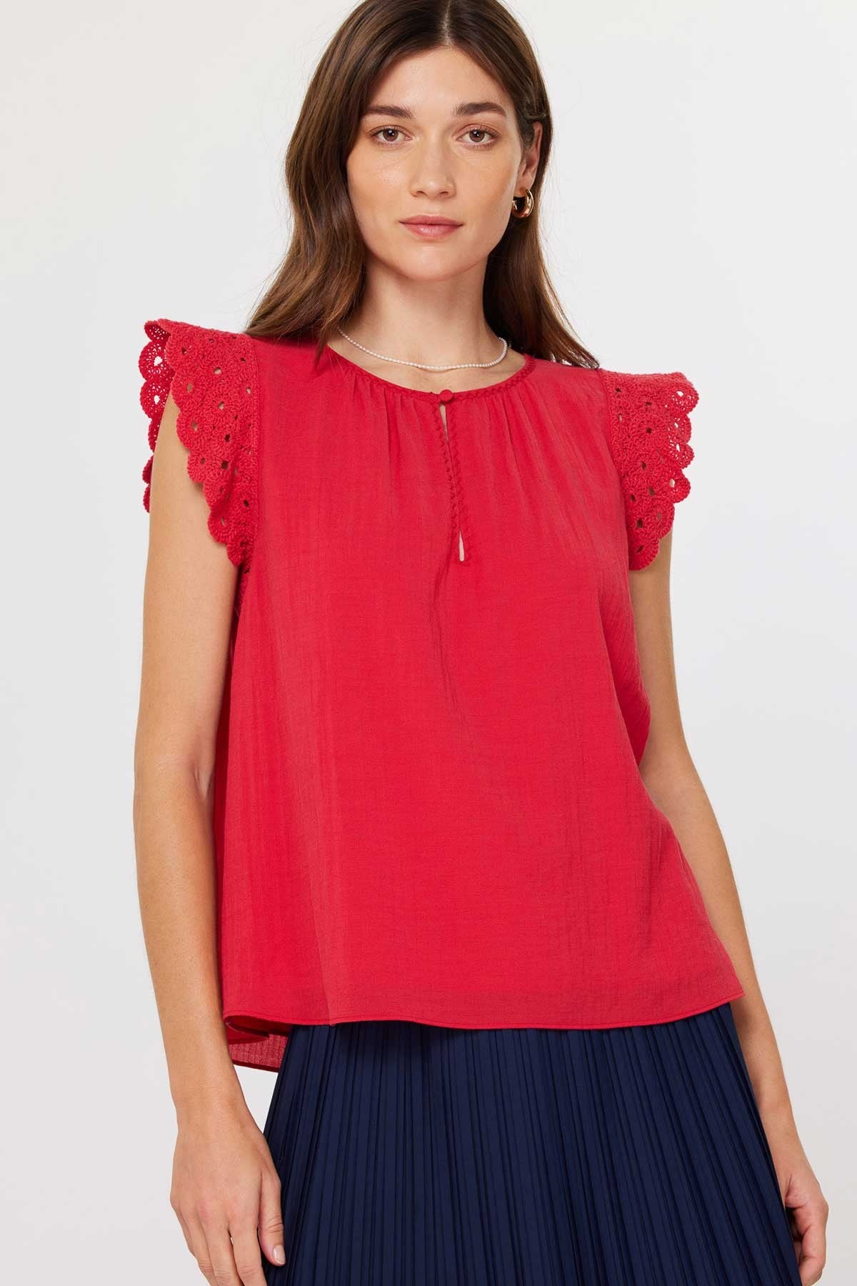 Annie Crochet sleeve blouse in light beige with round neck, front buttons, and short sleeves.