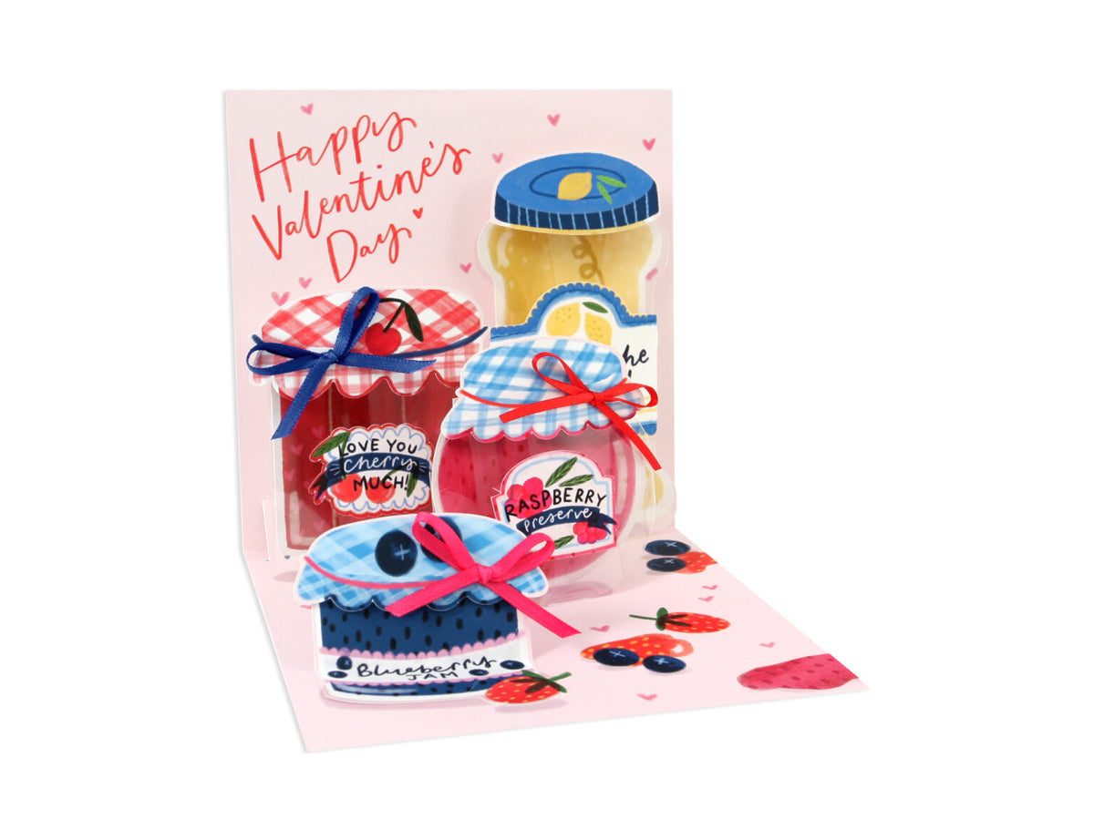 White Valentine's Day greeting card with orange marmalade theme, blueberry jam text, and red, pink, and blue bows.
