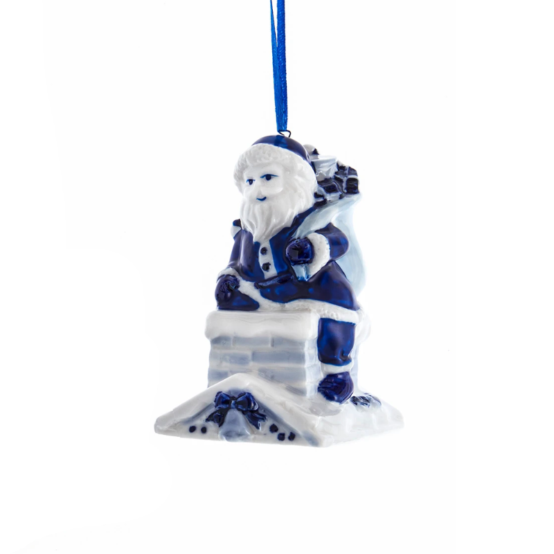 Blue and white ceramic Santa Claus ornament sitting on a chimney with a gift sack.
