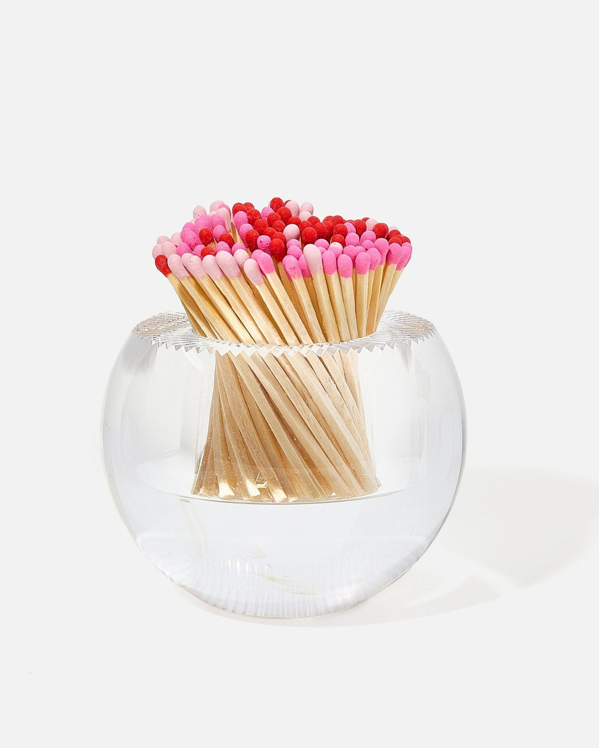 Round glass match striker filled with pink and red tipped matches.