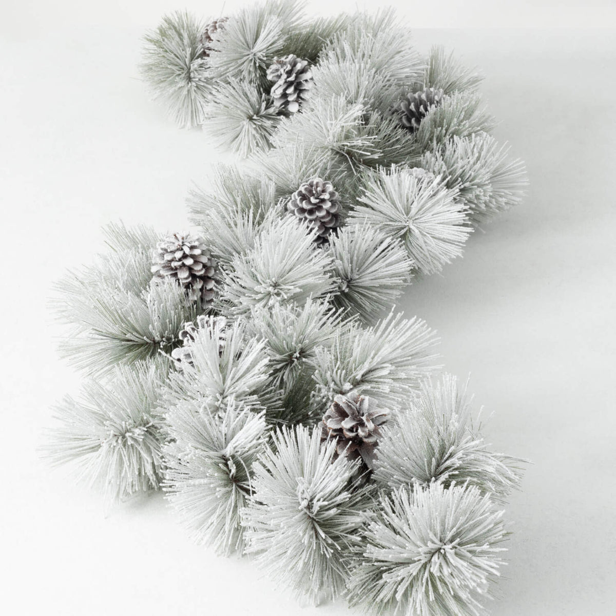 Green flocked pine garland with snow-covered look