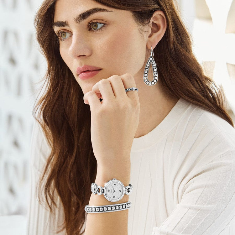 Woman wearing a silver-plated Portland Watch with a white dial and decorative link bracelet.