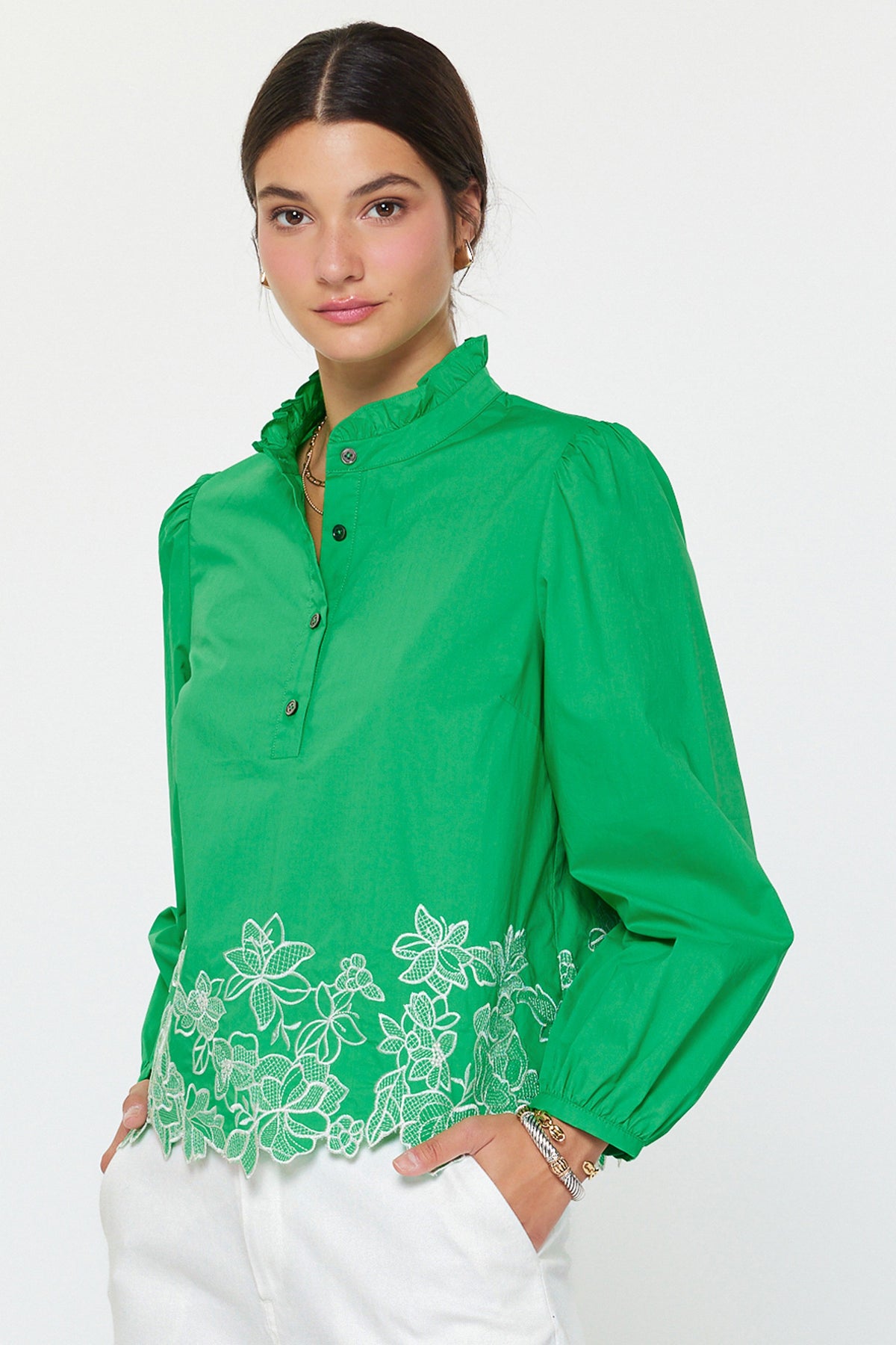 Lucy embroidered long sleeve blouse in cotton poplin with ruffle stand collar, puff sleeves, floral hem embroidery, and relaxed fit.