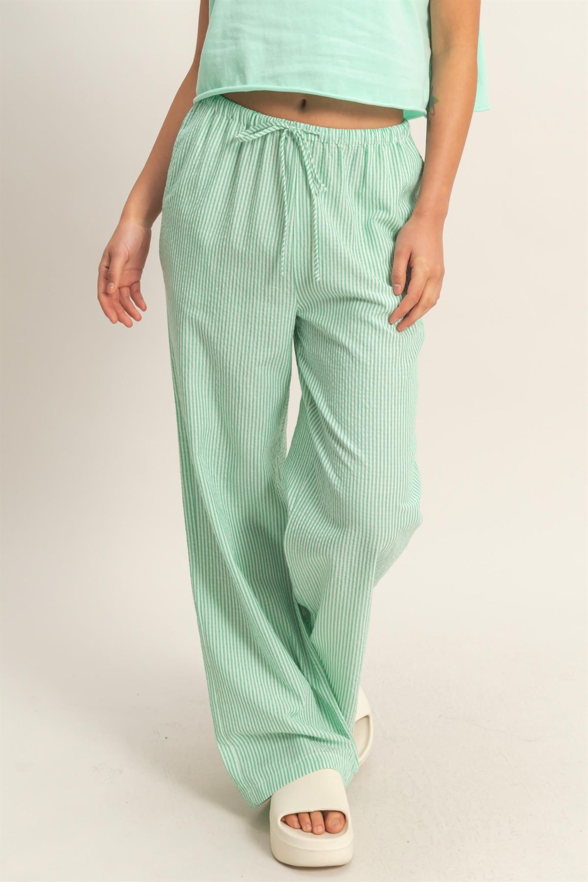 Arianne striped wide leg pants in a polyester rayon blend featuring vertical stripes.