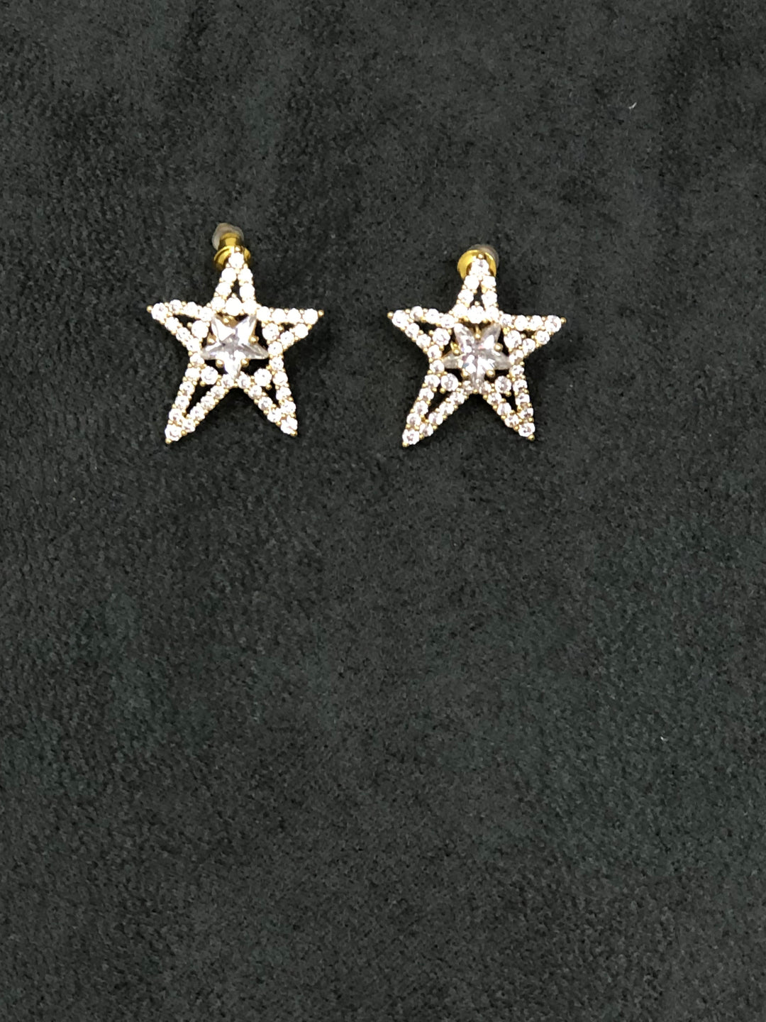 Crystal star earrings with gold plating and push back fasteners.