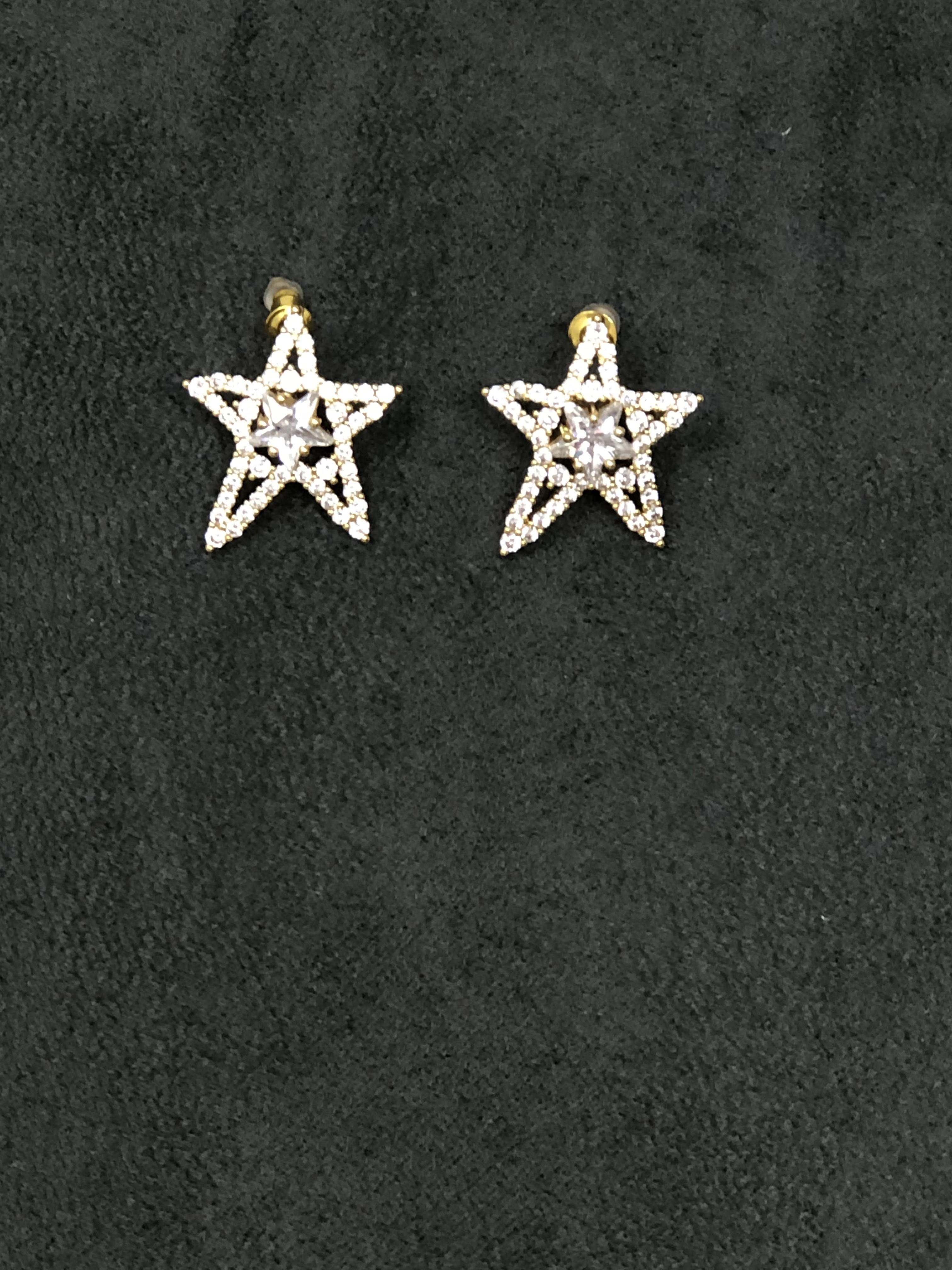 Crystal star earrings with gold plating and push back fasteners.