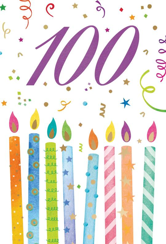 Black cylindrical candle with gold '100' on the front and a label reading 'Many Happy... wishes'