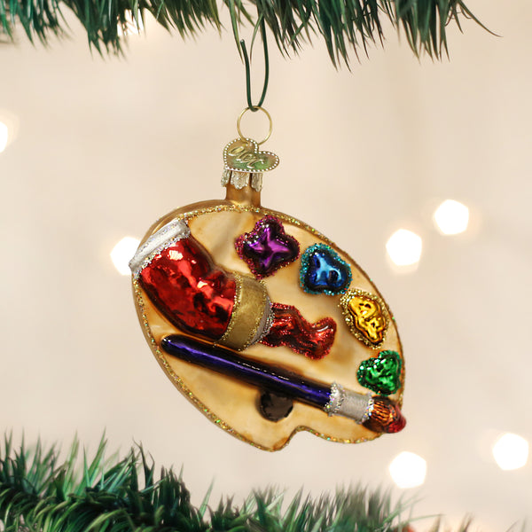 Artist's Palette Ornament with colorful paint dollops, a red paint tube, and a blue paintbrush.