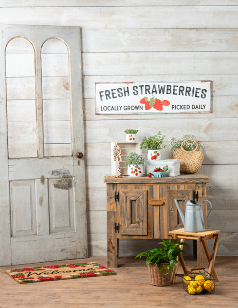 Multi-colored wall decor featuring a realistic strawberry fruit illustration with green leaves.