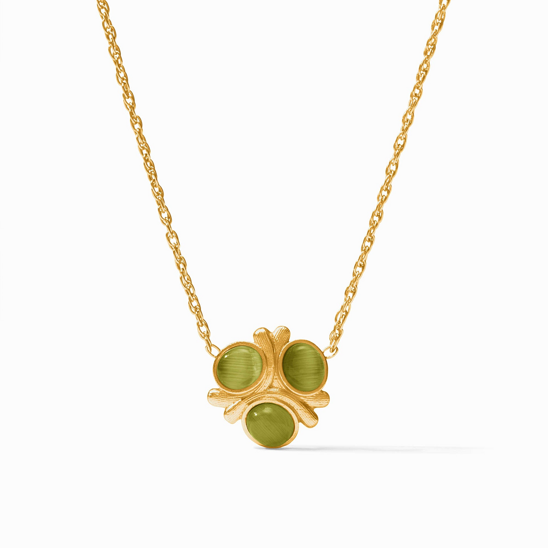 Gold chain necklace with a clover-shaped pendant featuring three round green glass stones.