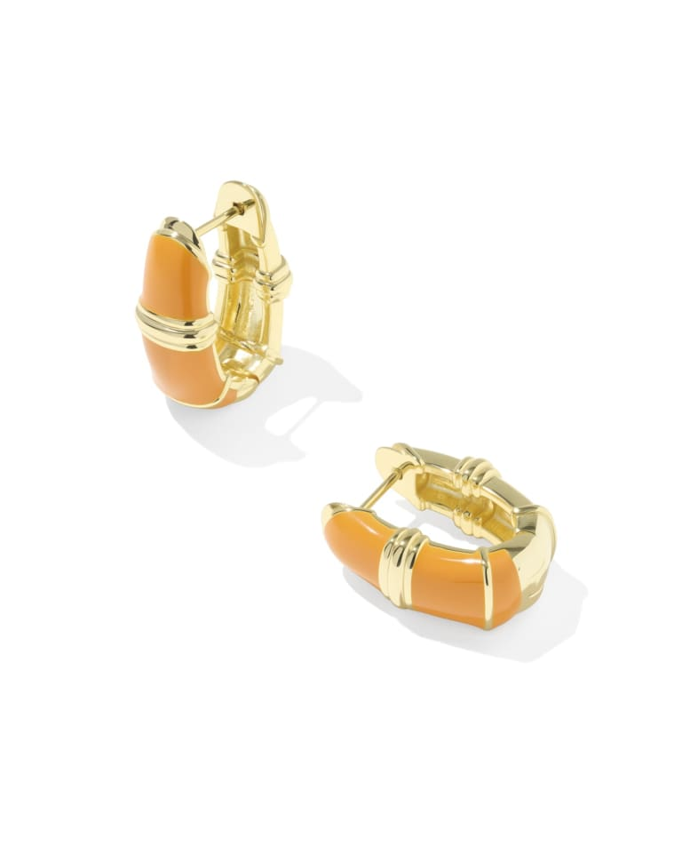 Pair of Courtney gold huggie earrings with orange enamel and textured metal detailing.