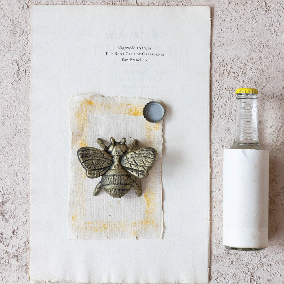 Cast iron bee bottle opener in distressed gold finish with a detailed insect silhouette.