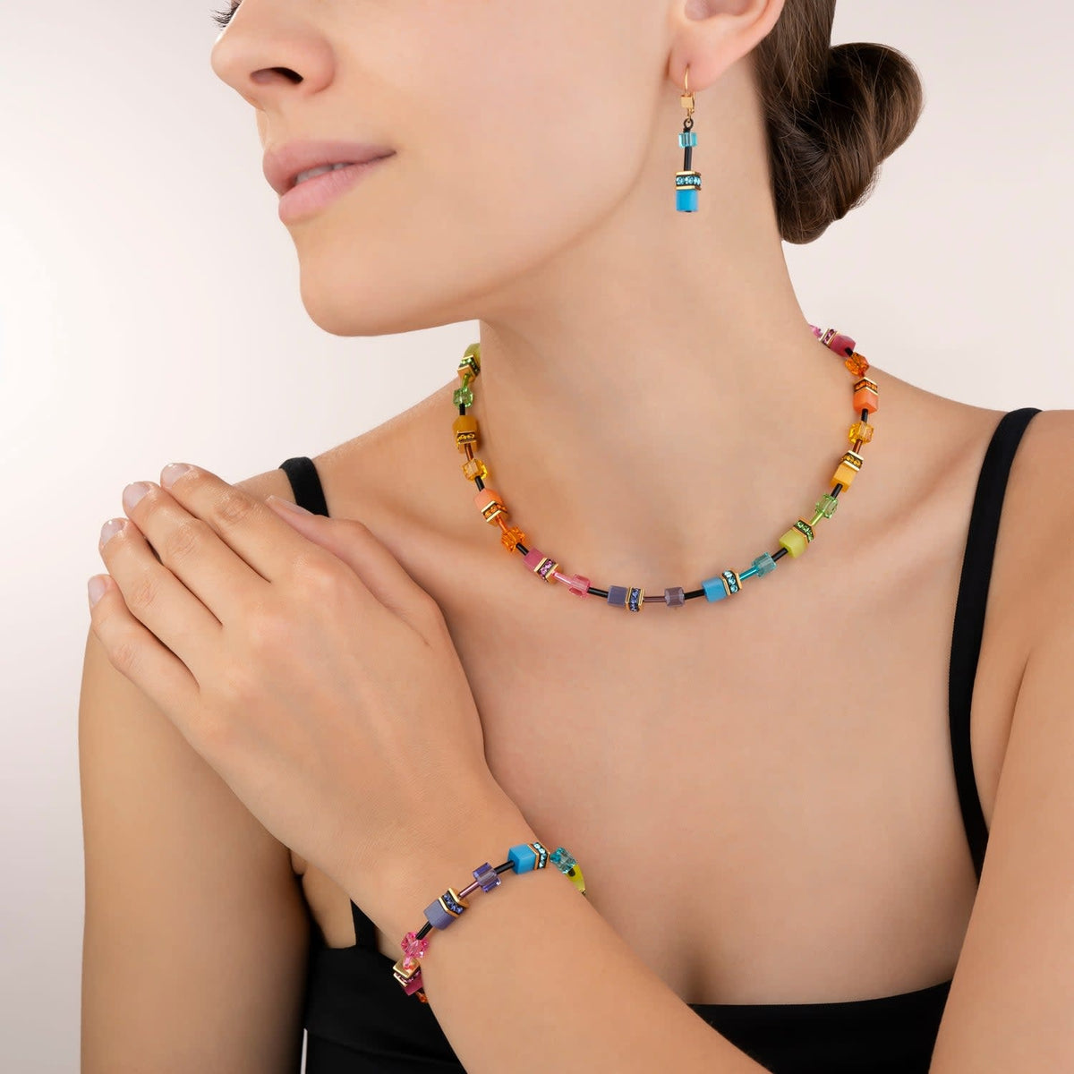 Multicolour rainbow gold Geocube bracelet featuring synthetic tiger's eye stones with Swarovski crystals and rhinestone rondelles on a stainless steel chain.