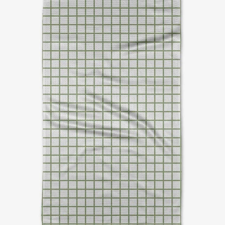 Green and white checkered waffle weave tea towel with a hanging loop.