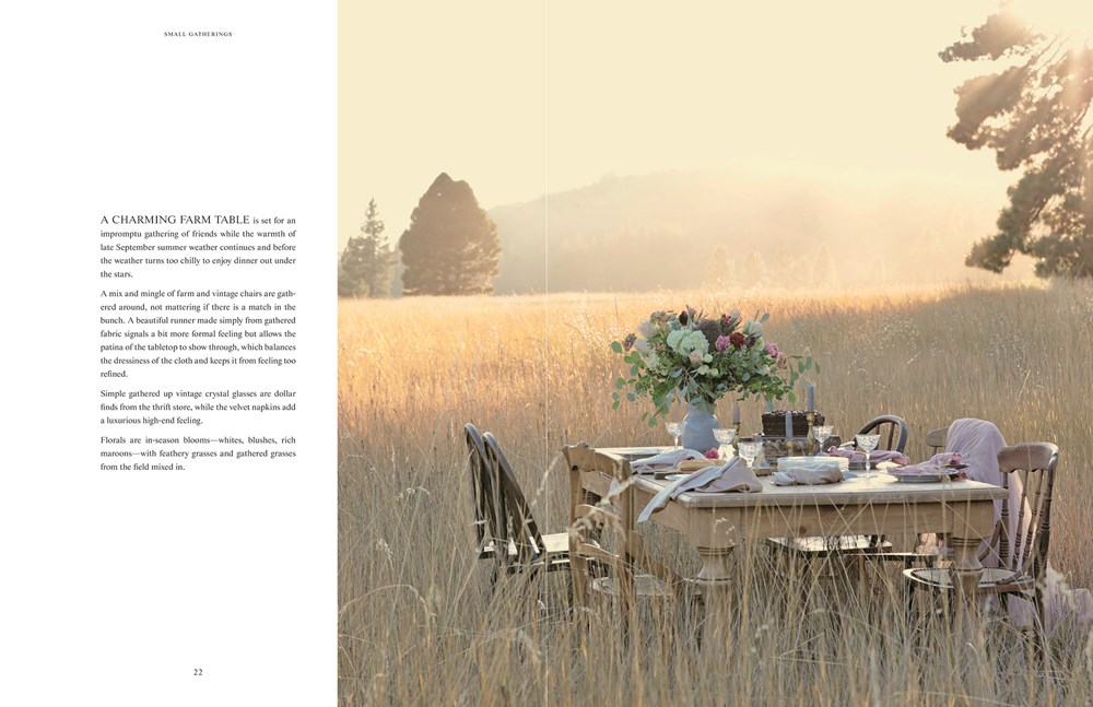 Open book page showing a rustic wooden table set for a meal in a golden field at sunset.