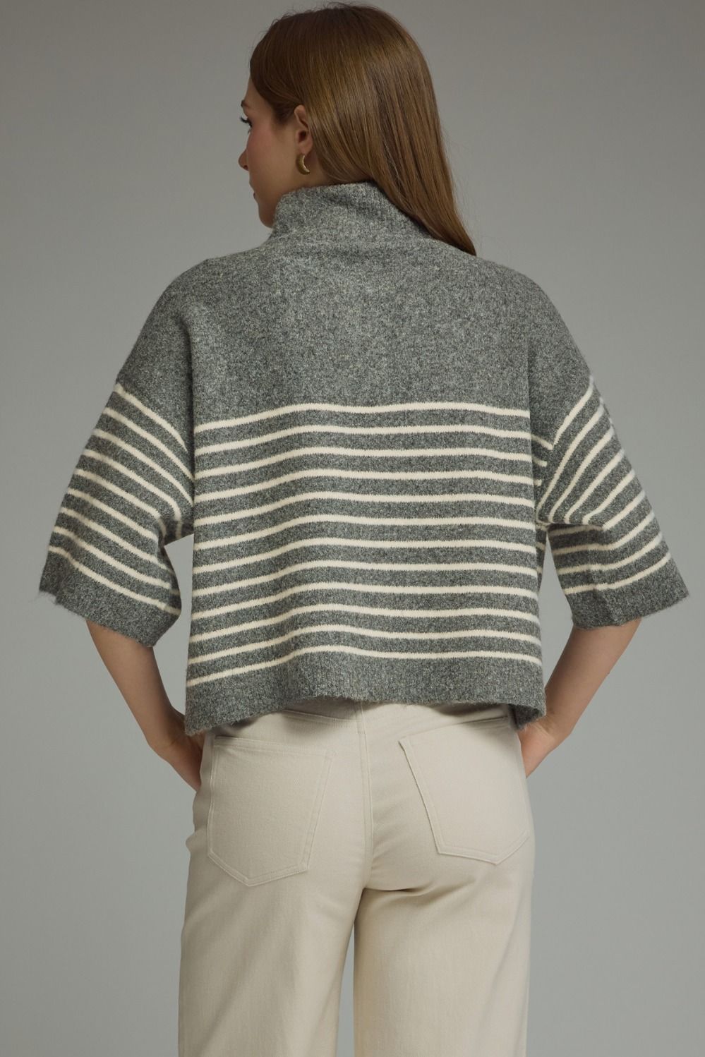 Back view of a woman wearing the Charlene Stripe Short Sleeve Knit Top in grey with white stripes.