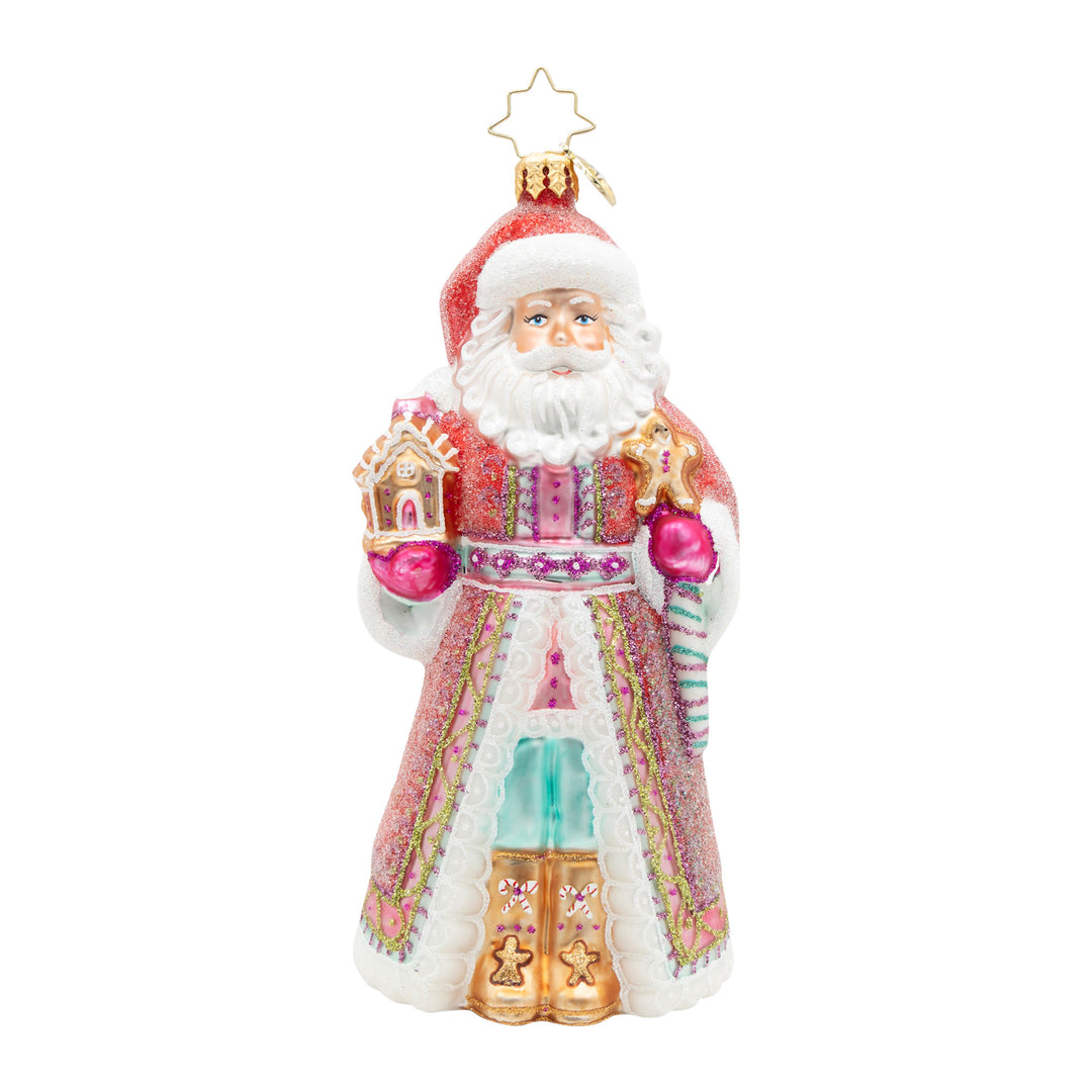 The Claus Confection glass Santa ornament holding a gingerbread house and gingerbread man.