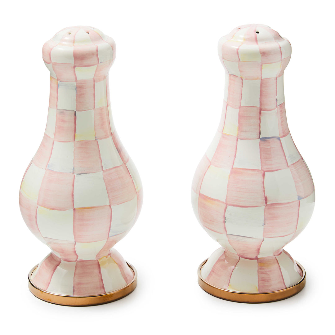 A pair of large salt and pepper shakers with a hand-painted pink and white rosy check pattern.