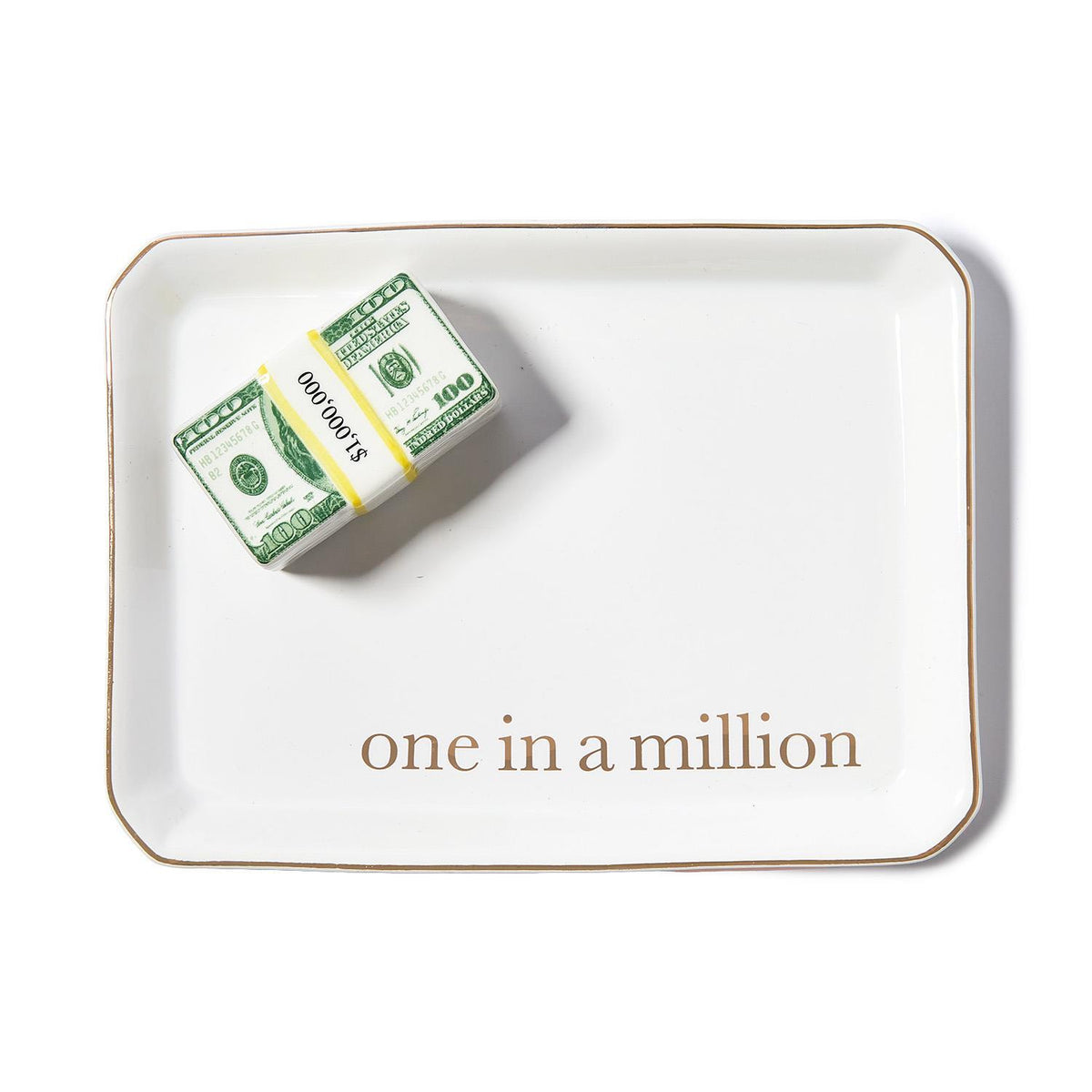 White ceramic trinket tray with gold trim, a stack of play money, and "one in a million" text.