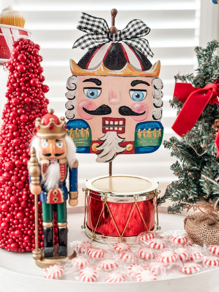 Wooden nutcracker charm with a classic soldier silhouette in red and green colors.