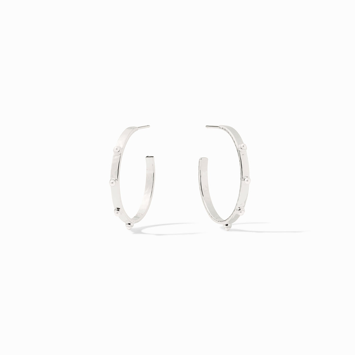 Pair of silver crescent hoop earrings featuring small white stone studs along the outer edge.