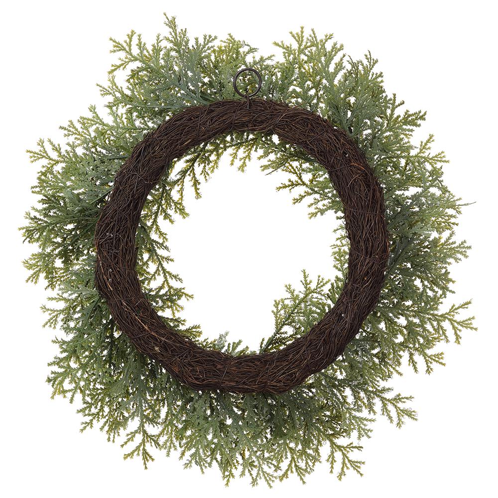 24-inch iced cedar wreath with green frosted foliage on a brown grapevine base.