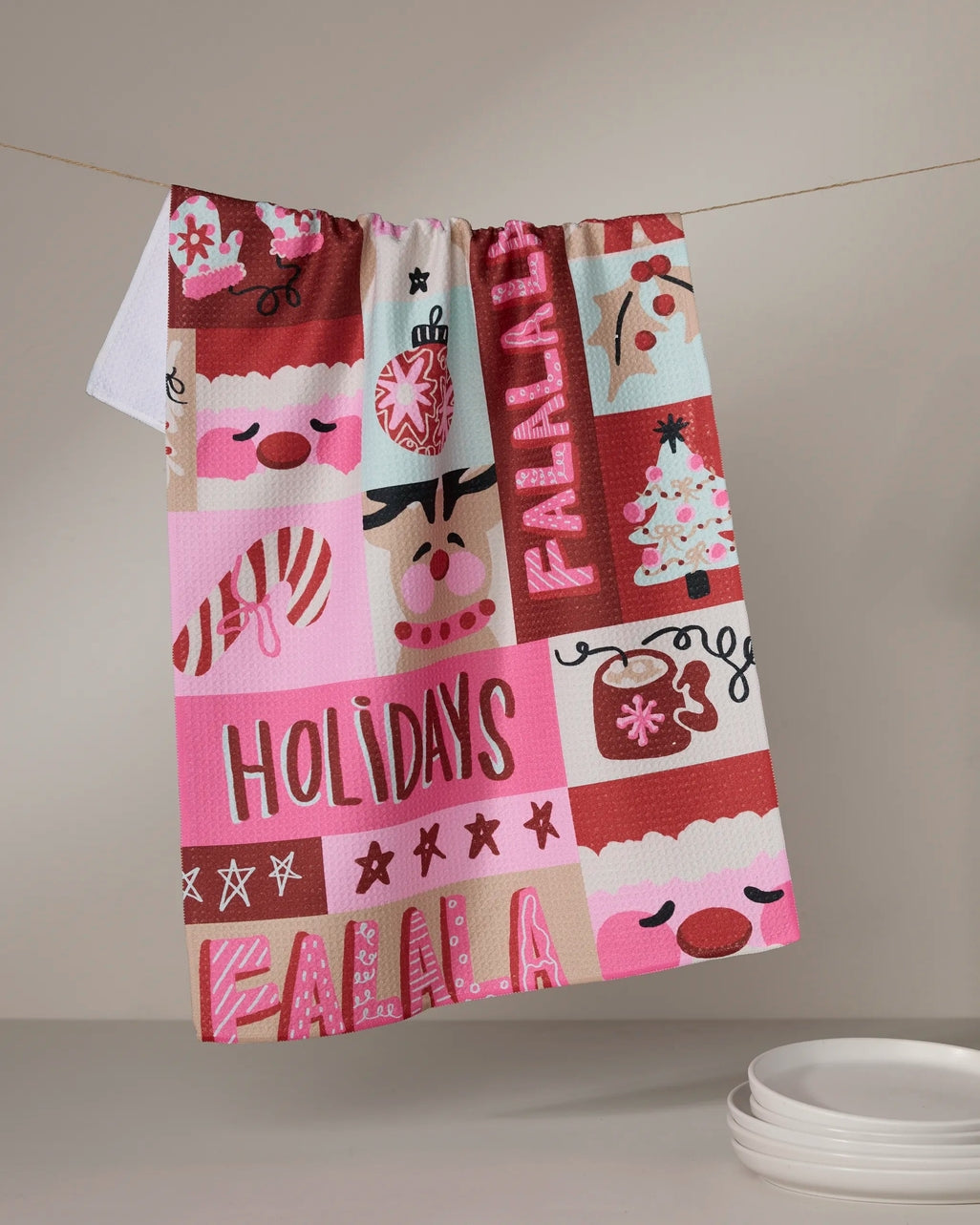 Holiday tea towel with waffle weave construction in red featuring a festive pattern.