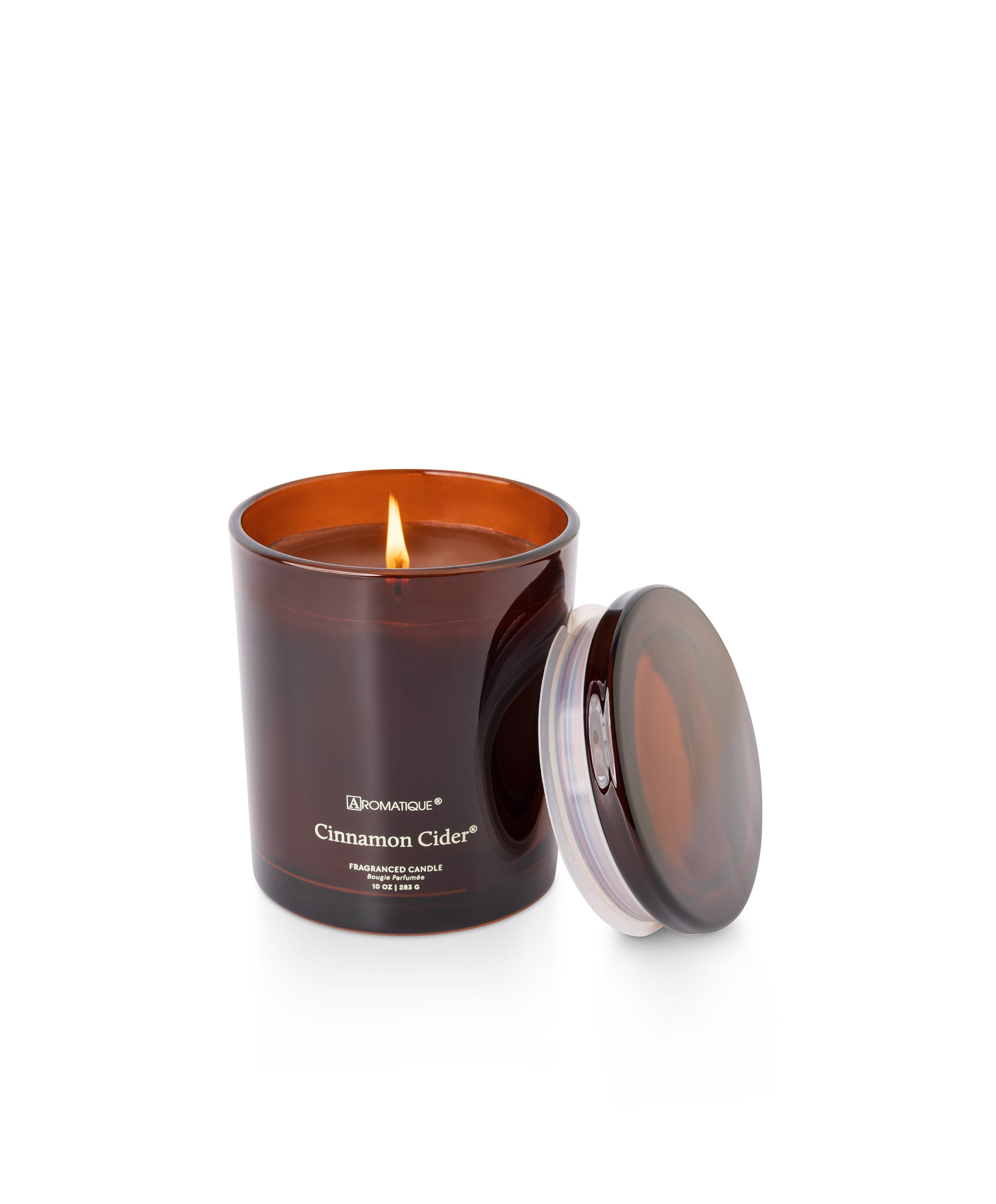 Cinnamon Cider 10 oz candle in a deep amber glass jar with a lit wick and matching lid.