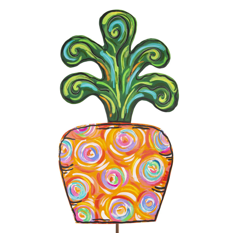 Artful carrot garden stake with green leafy top and orange body decorated with colorful swirls.