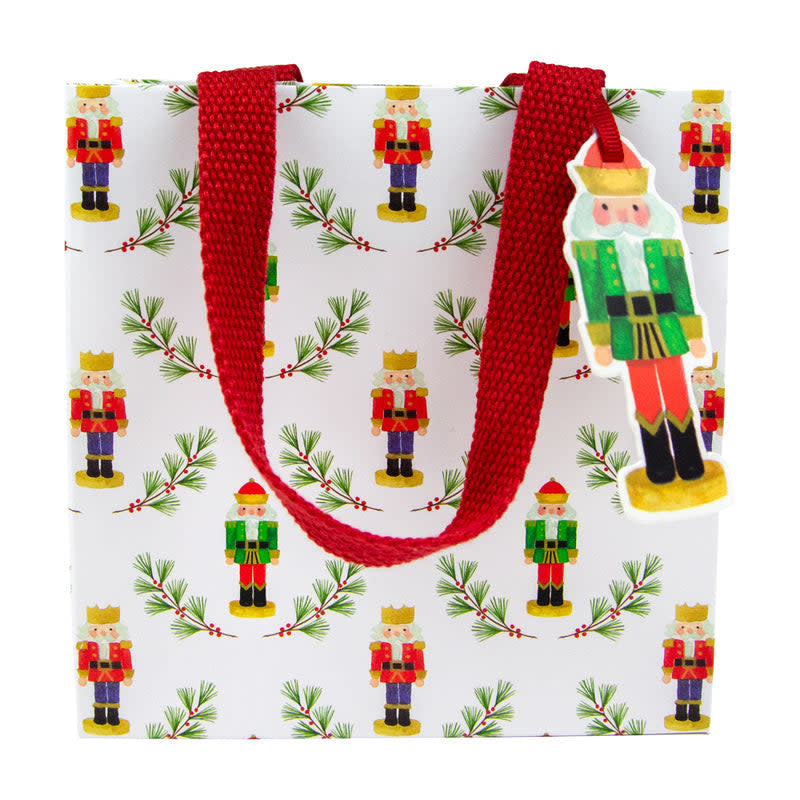Small gift bag with red nutcracker print on durable paper featuring a strong handle.