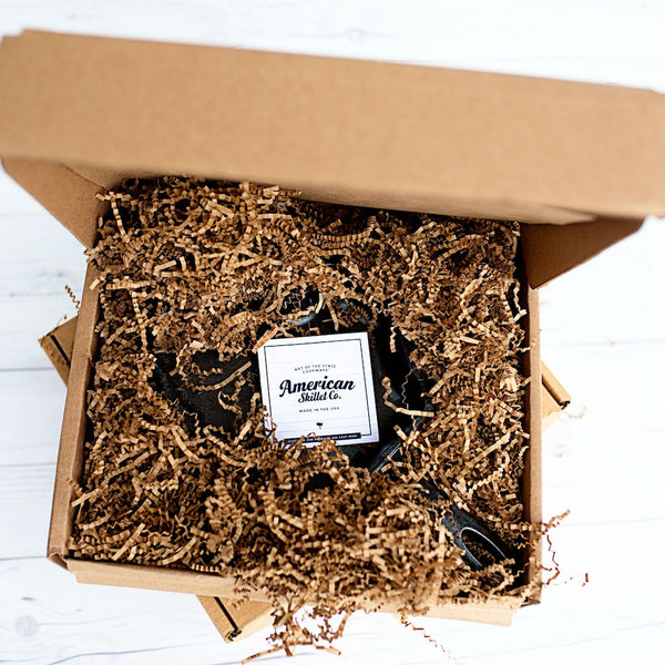 Oklahoma state-shaped cast iron skillet in an open gift box with black handle