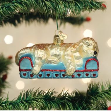 Sleepy Doodle dog ornament in cream with brown ears and tail, sitting upright.